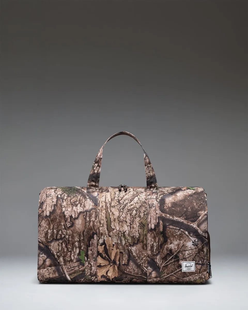 herschel-supply-novel-duffle-bag-with-realtree-apx-camo-carry-on-size-shoe-compa image 1